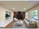 Spacious living room features a modern fireplace, wood floors, stylish furniture, and abundant natural light, creating a welcoming atmosphere at 2571 Stanford Dr, Ellenwood, GA 30294