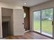 Living room with wood floors, slider doors to exterior, accent wall and interior door at 2571 Stanford Dr, Ellenwood, GA 30294