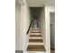 Stairway with light wood treads and white risers, complemented by white walls and a dark wood handrail at 2571 Stanford Dr, Ellenwood, GA 30294