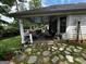 Relaxing covered back porch with seating area and stone-paved ground at 187 Pine Branch Dr, Stockbridge, GA 30281