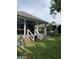 Back porch with white railings overlooks a lush green yard with mature trees and plants at 187 Pine Branch Dr, Stockbridge, GA 30281