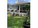 Spacious back porch with outdoor seating, white railings, and a view of the landscaped yard at 187 Pine Branch Dr, Stockbridge, GA 30281