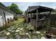 Cozy backyard featuring a wooden patio cover over an outdoor cooking area and stone paver accents at 187 Pine Branch Dr, Stockbridge, GA 30281