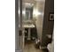 Cozy half bath features a pedestal sink, stylish fixtures, and warm neutral tones at 187 Pine Branch Dr, Stockbridge, GA 30281