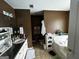 Well-lit bathroom with a vanity, tub, and ample storage space at 187 Pine Branch Dr, Stockbridge, GA 30281