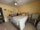Bright bedroom with decorative white metal bed, ceiling fan, and personal decor at 187 Pine Branch Dr, Stockbridge, GA 30281