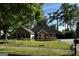 Charming brick home featuring a well-manicured front yard with vibrant flowerbeds and mature shade trees at 187 Pine Branch Dr, Stockbridge, GA 30281