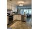 Bright kitchen with stainless steel appliances, white cabinets, and a window-filled dining area at 187 Pine Branch Dr, Stockbridge, GA 30281