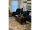 Comfortable living room area with plush seating, wooden coffee table, and decorative rug at 187 Pine Branch Dr, Stockbridge, GA 30281