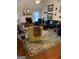 Inviting living room with brick fireplace, wood floors, a comfortable seating arrangement and lots of natural light at 187 Pine Branch Dr, Stockbridge, GA 30281