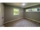 This bedroom offers natural light from two windows and wood-style laminate flooring at 2836 Belaire Cir, Doraville, GA 30340