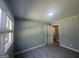Bright bedroom features neutral walls and gray laminate wood flooring at 2836 Belaire Cir, Doraville, GA 30340