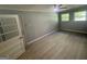 A sunlit bonus room or bedroom, with wood-style laminate flooring and ceiling fan at 2836 Belaire Cir, Doraville, GA 30340