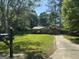 View of the home from the street, featuring a well-manicured lawn and a mailbox with the address at 2836 Belaire Cir, Doraville, GA 30340
