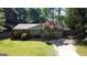 Charming single story brick home featuring a well-manicured lawn and a mature tree in the front yard at 2836 Belaire Cir, Doraville, GA 30340