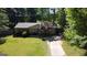 Charming single story brick home featuring a well-manicured lawn and a mature tree in the front yard at 2836 Belaire Cir, Doraville, GA 30340