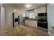 Bright kitchen features stainless steel appliances, granite countertops, and white cabinets at 2836 Belaire Cir, Doraville, GA 30340