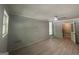 Spacious living room with brick accent wall, and wood-style laminate floors at 2836 Belaire Cir, Doraville, GA 30340