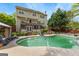 Large backyard featuring a swimming pool, patio, two-story house, and mature trees for privacy at 122 Ardenlee Dr, Peachtree City, GA 30269