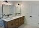 Bright bathroom featuring double vanity, marble backsplash, and modern fixtures at 409 Saint Surrey Way, Ellenwood, GA 30294