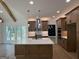 Spacious open kitchen with an island, stainless steel appliances, custom cabinets, and modern lighting fixtures at 409 Saint Surrey Way, Ellenwood, GA 30294