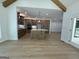 Open-concept kitchen with stainless steel appliances, an island, custom cabinets, and hardwood flooring at 409 Saint Surrey Way, Ellenwood, GA 30294