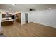 Bright living room with hardwood floors leading to a modern kitchen with an island and custom cabinetry at 409 Saint Surrey Way, Ellenwood, GA 30294
