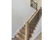 Modern staircase with wood steps, a black metal railing, and recessed lighting, offering a sleek and stylish design at 409 Saint Surrey Way, Ellenwood, GA 30294