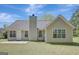 Back exterior showcasing a home's siding, roof, patio, chimney, and lush lawn at 8032 Highland Pkwy, Fairburn, GA 30213