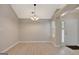 Spacious dining area features modern flooring and a stylish chandelier, perfect for entertaining guests at 8032 Highland Pkwy, Fairburn, GA 30213