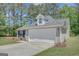 Charming home with a two-car garage, stone facade, and a well-kept lawn, creating a welcoming curb appeal at 8032 Highland Pkwy, Fairburn, GA 30213