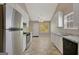 Eat-in kitchen featuring white cabinets, stainless steel appliances, and an adjacent dining area at 8032 Highland Pkwy, Fairburn, GA 30213