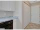 Bright kitchen showcasing white cabinets, marble countertops, and modern appliances near pantry door at 8032 Highland Pkwy, Fairburn, GA 30213