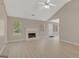Bright living room boasts light flooring, a cozy fireplace, and large windows, creating an inviting atmosphere at 8032 Highland Pkwy, Fairburn, GA 30213