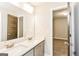 Bright bathroom featuring double sinks with white countertops and modern fixtures at 1700 Cobblefield Cir, Dacula, GA 30019