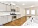 Modern kitchen with stainless steel appliances, granite countertops, and a marble backsplash at 1700 Cobblefield Cir, Dacula, GA 30019