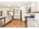 Open kitchen with stainless steel appliances, granite countertops, and a center island at 1700 Cobblefield Cir, Dacula, GA 30019