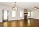 Bright living room with hardwood floors, recessed lighting, and a stone fireplace at 1700 Cobblefield Cir, Dacula, GA 30019