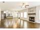 Spacious living room with hardwood floors, a stone fireplace, and plenty of natural light at 1700 Cobblefield Cir, Dacula, GA 30019