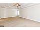 Spacious main bedroom with a tray ceiling, ceiling fan, and neutral carpeting at 1700 Cobblefield Cir, Dacula, GA 30019