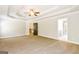 Bright main bedroom with a tray ceiling, recessed lighting, and neutral carpeting at 1700 Cobblefield Cir, Dacula, GA 30019