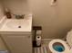 Cozy bathroom with a white vanity, toilet, and neutral wall color at 6935 Oakhill Cir, Austell, GA 30168
