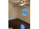 Bedroom featuring hardwood floors, a ceiling fan, and natural light from the window at 6935 Oakhill Cir, Austell, GA 30168