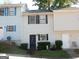 Traditional townhouse featuring neutral siding, black shutters, and a well-maintained lawn at 6935 Oakhill Cir, Austell, GA 30168