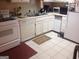 Functional kitchen with white appliances, tile flooring, and ample counter space at 6935 Oakhill Cir, Austell, GA 30168