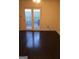 Living room featuring hardwood floors and access to the backyard through glass doors at 6935 Oakhill Cir, Austell, GA 30168