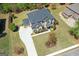 Aerial view of a two-story brick home with a three car garage and manicured landscaping at 266 Shellbark Dr, Mcdonough, GA 30252
