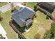 Aerial view of a brick house with a dark roof and a patio set on the lawn at 266 Shellbark Dr, Mcdonough, GA 30252