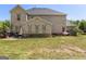 Backyard with a brick house, patio set and green lawn, showing windows at 266 Shellbark Dr, Mcdonough, GA 30252
