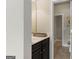 Powder room with dark wood vanity and a mirror, attached to another room at 266 Shellbark Dr, Mcdonough, GA 30252